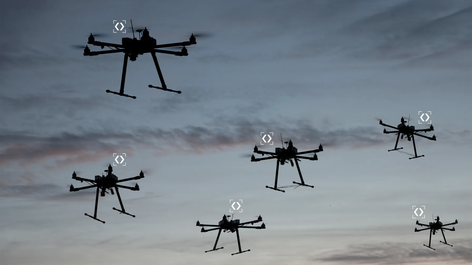 A swarm of autonomous drones silhouetted against a dusk sky, each marked by a targeting bracket